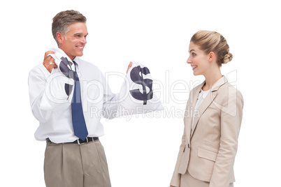 Smiling mature businessman showing money bags to his coworker