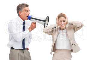 Businessman yelling at his coworker with megaphone