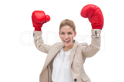 Cheering businesswoman wearing boxing gloves