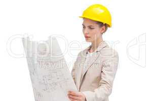 Pretty architect examining construction plan