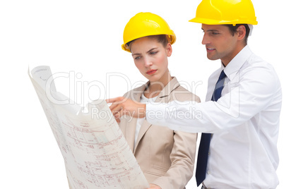Serious architects looking at construction plan