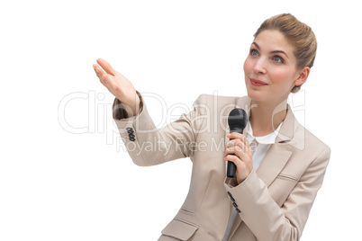 Businesswoman with microphone pointing at something