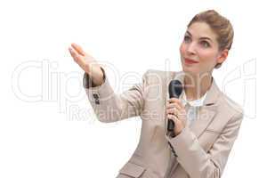 Businesswoman with microphone pointing at something