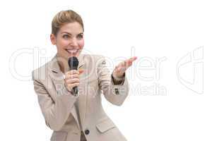 Businesswoman with microphone showing something