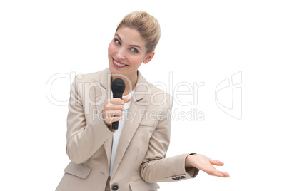 Amazed businesswoman speaking on microphone