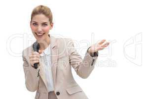Gesturing businesswoman speaking on microphone