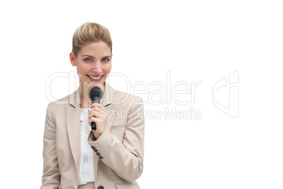 Stylish businesswoman holding microphone