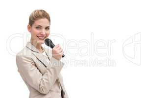 Pretty businesswoman holding microphone