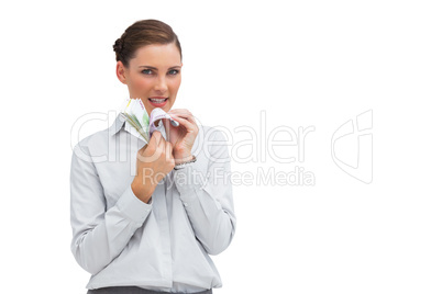 Businesswoman counting money and looking at camera