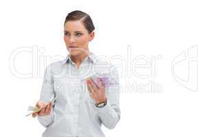 Businesswoman holding wads of cash