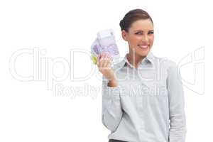 Happy businesswoman showing lots of money