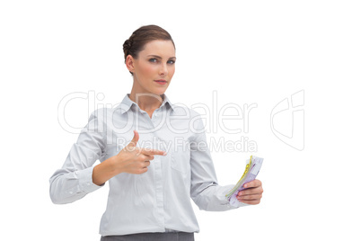 Businesswoman pointing to money in her hand