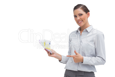 Happy businesswoman showing money in her hand