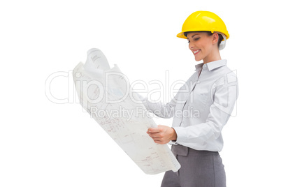 Architect reading a plan with yellow helmet