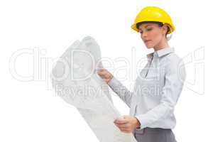Architect studying plan with yellow helmet
