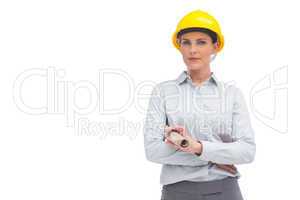 Architect with yellow helmet and rolled up plan
