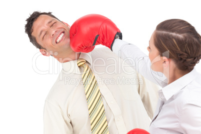 Businesswoman knocking out a businessman with boxing gloves