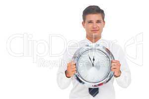 Nervous businessman holding a clock