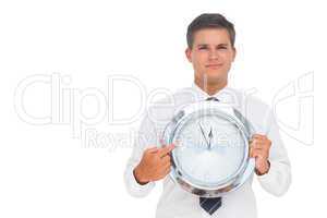 Businessman holding a clock