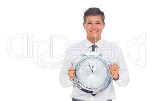 Concerned businessman holding clock