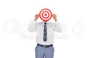Businessman hiding his face behind a red target