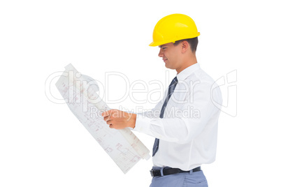 Architect reading a plan with yellow helmet