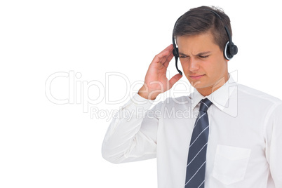 Call centre agent using headset and touching it