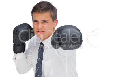 Businessman hitting with black boxing gloves