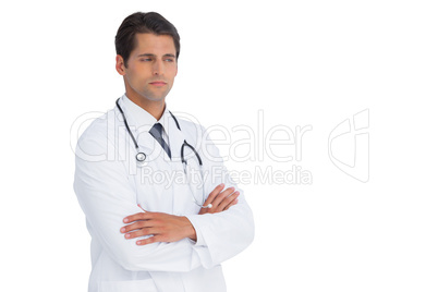 Doctor with arms crossed frowning