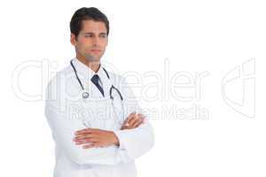 Doctor with arms crossed frowning