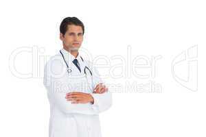 Handsome doctor standing with arms crossed