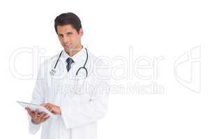 Handsome doctor using a tablet