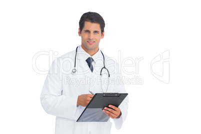 Doctor holding a clipboard and pen and smiling