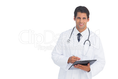 Smiling doctor holding a clipboard and pen