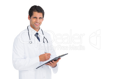 Handsome doctor holding a clipboard and pen