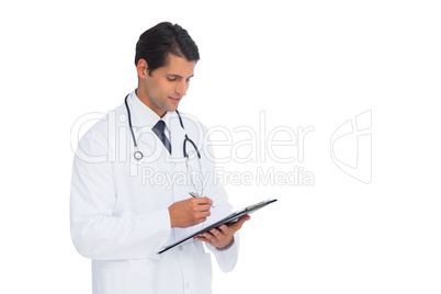 Smiling doctor holding pen and clipboard