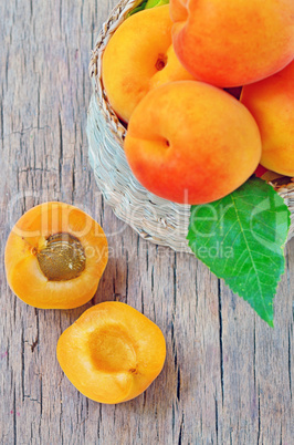 fruits apricot in basket on wooden background