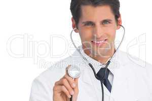 Doctor smiling and holding up stethoscope