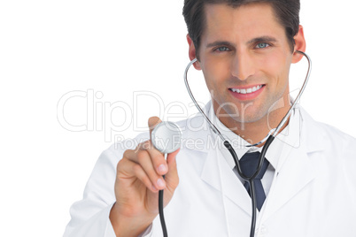 Smiling doctor holding up stethoscope