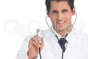 Smiling doctor holding up stethoscope