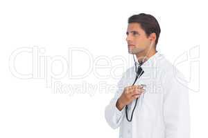 Serious doctor holding up stethoscope to his chest