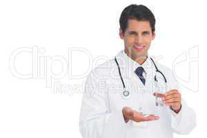Happy doctor smiling and holding medicine