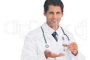Happy doctor smiling and holding tablets and water