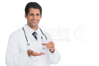 Cheerful doctor holding tablets and water