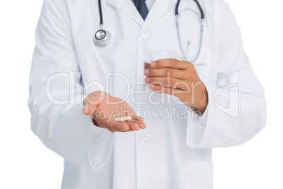 Doctor holding drugs and glass of water