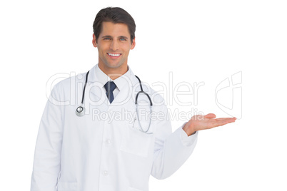 Happy doctor showing something and smiling