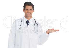 Happy doctor showing something and smiling