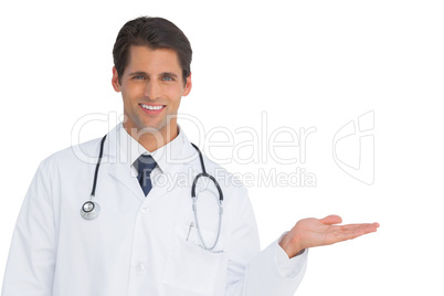 Smiling doctor showing something