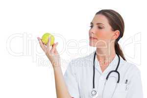 Happy nurse holding an apple