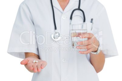 Nurse holding medicine and glass of water